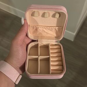 Two pink travel jewelry cases